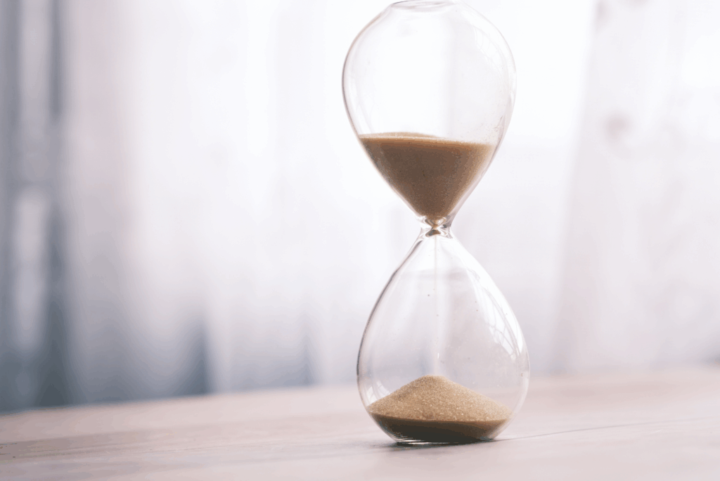An hourglass with sand running through it, symbolizing how timing affects parole preparation and legal outcomes in Texas.