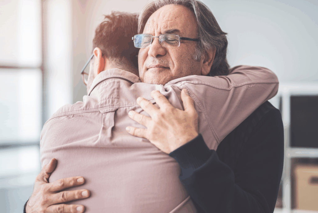 A man embraces an older loved one, representing family support and emotional moments during the Texas parole process.