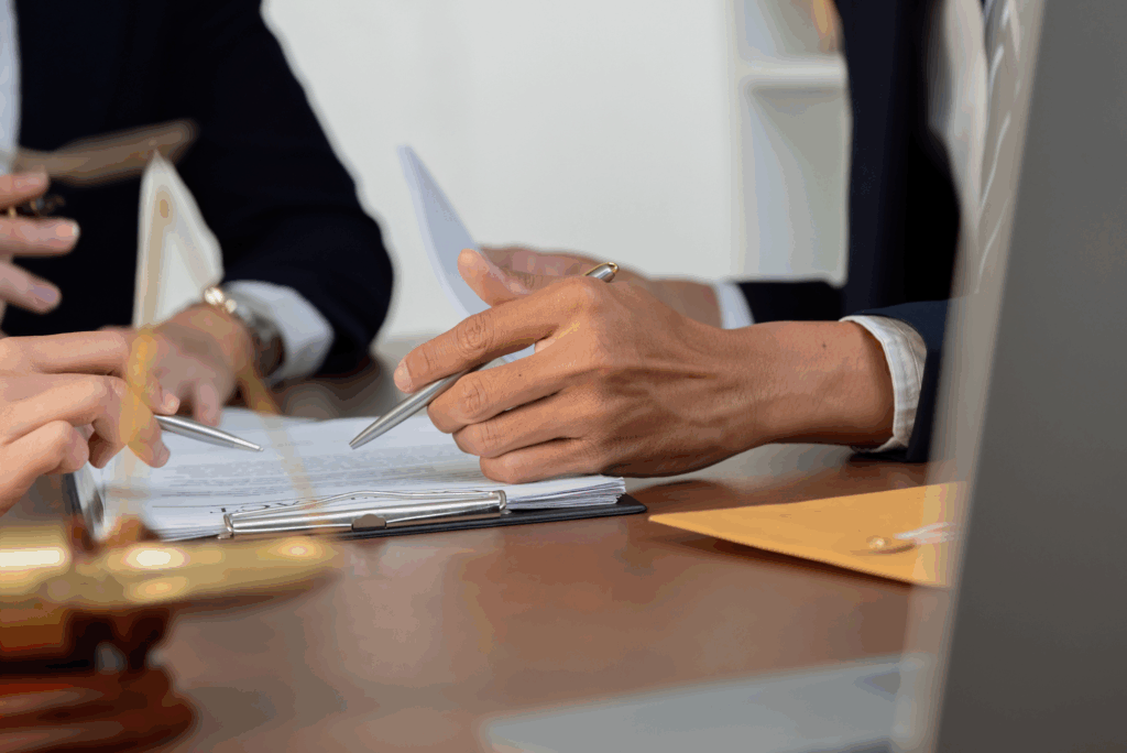Attorneys sitting at a desk reviewing documents and taking notes, showing the detailed preparation required for effective parole representation in Texas.