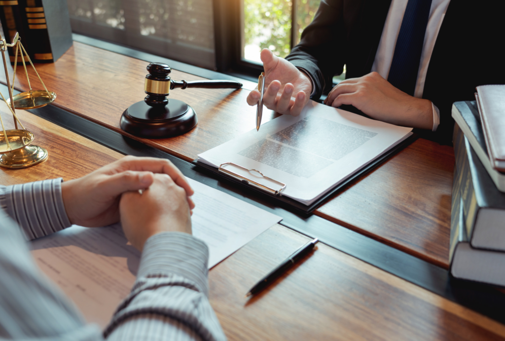Defense attorney consulting with a client about early parole termination in Texas, with legal documents and justice scales on the table.